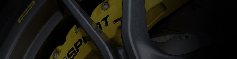 A yellow TTSPORT Evolution Series 8-piston big brake kit.